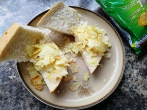 Two open baguette segments with crisps on