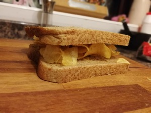 Close up of brown crisp sandwich on chopping board