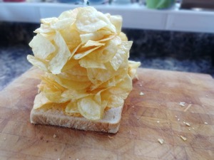 Oodles of crisps piled onto white bread