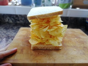 White bread containing a big pile of potato crisps