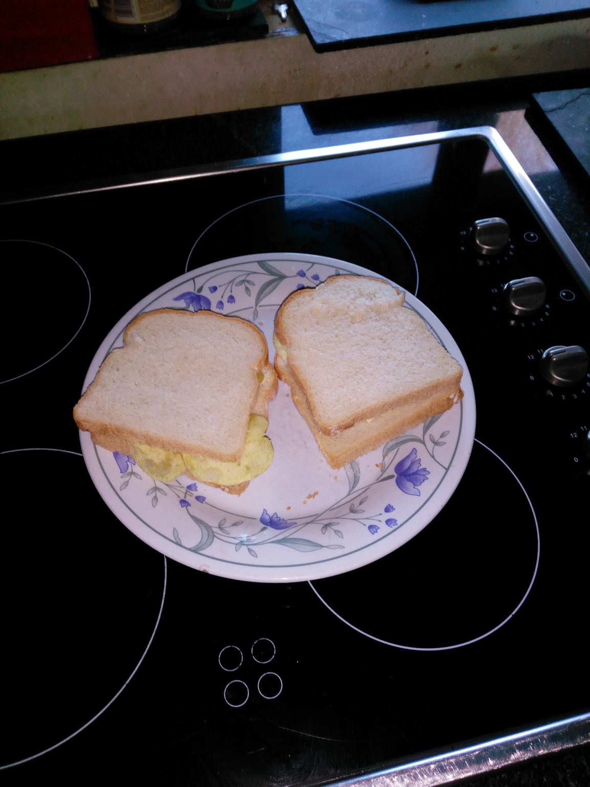 Two white crisp sandwiches placed on a cooker