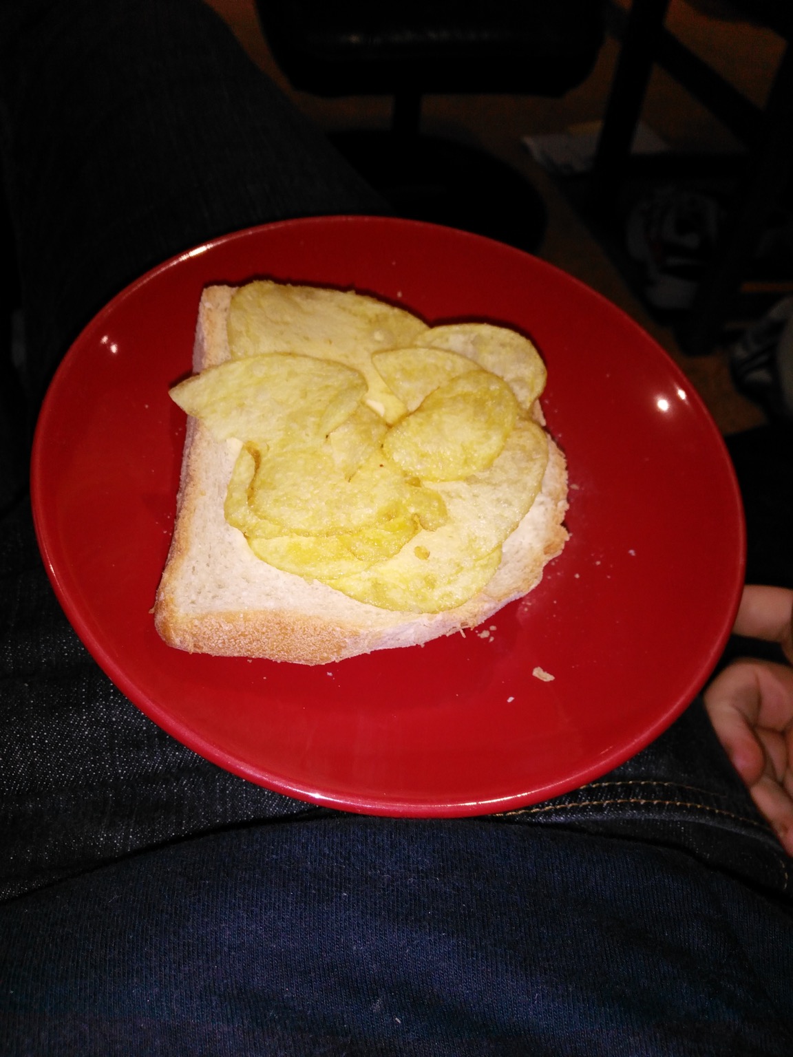 Flash photo of potato crisps on sliced white bread