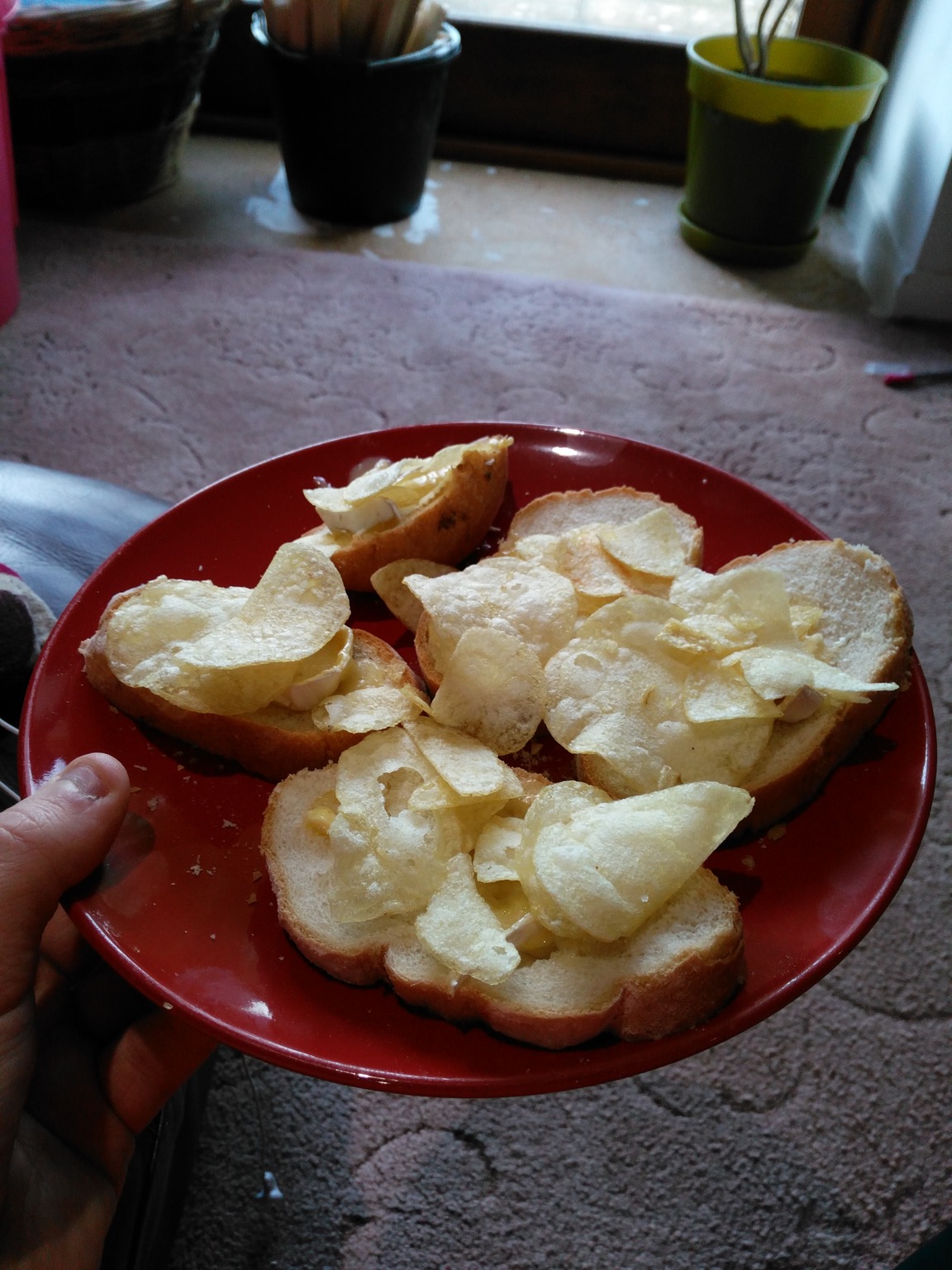 Crisps and cheese on slices of white bread