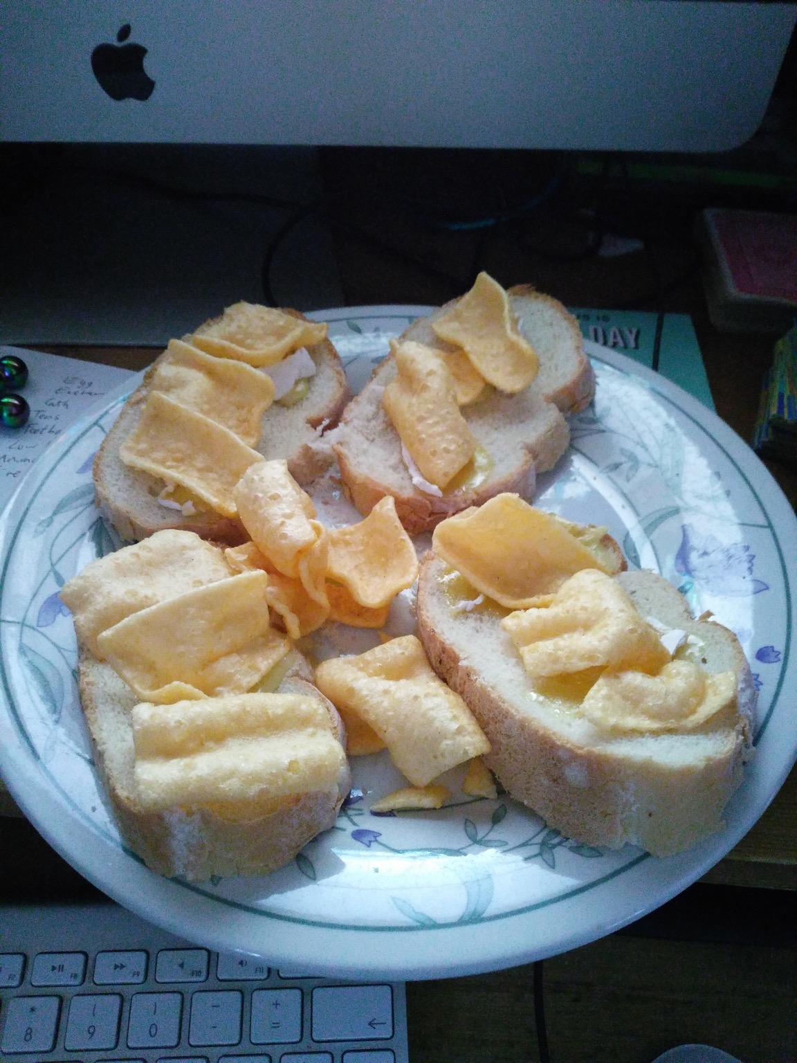 Corn snacks and brie on sliced white bread