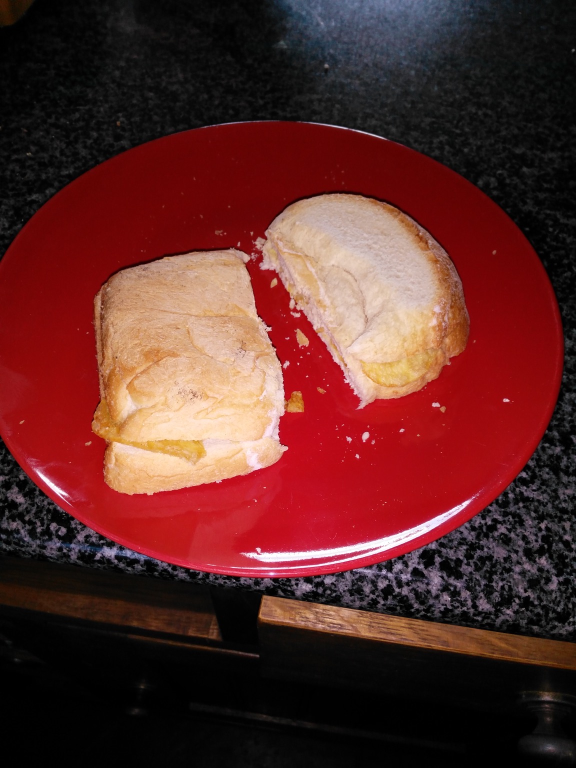 Flash photo of halved white crisp sandwich