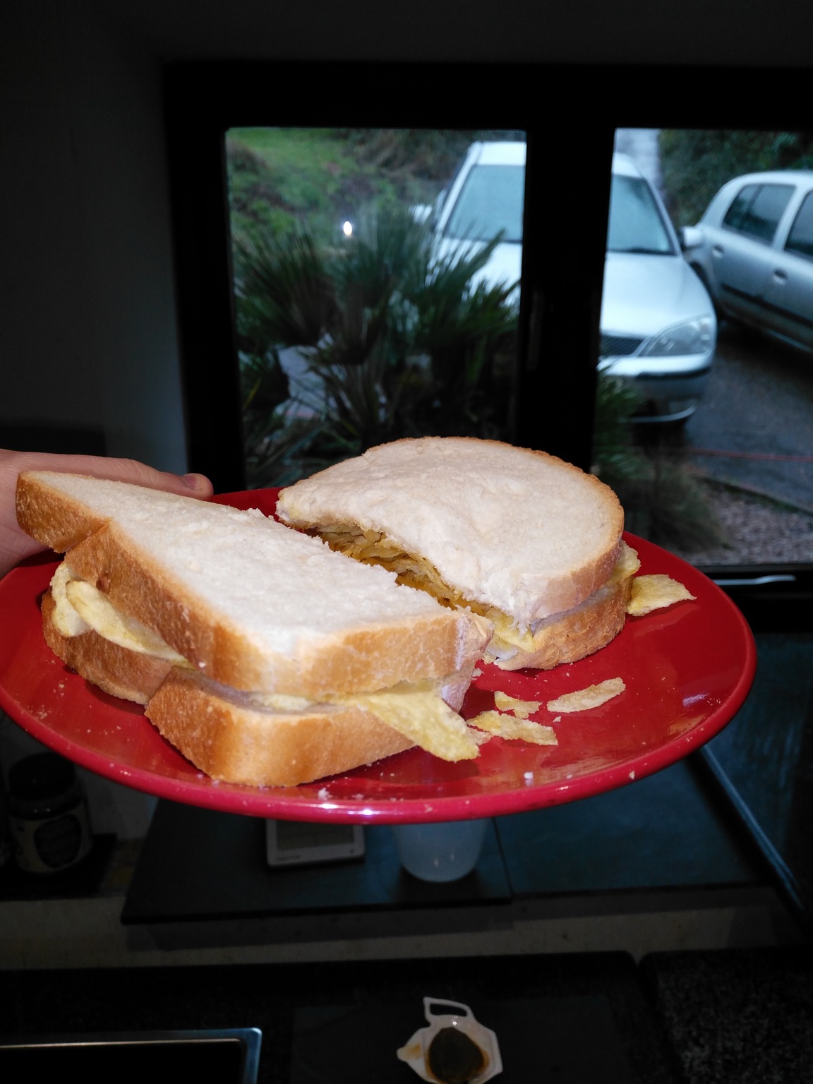 Halved crisp sandwich being shown to cars