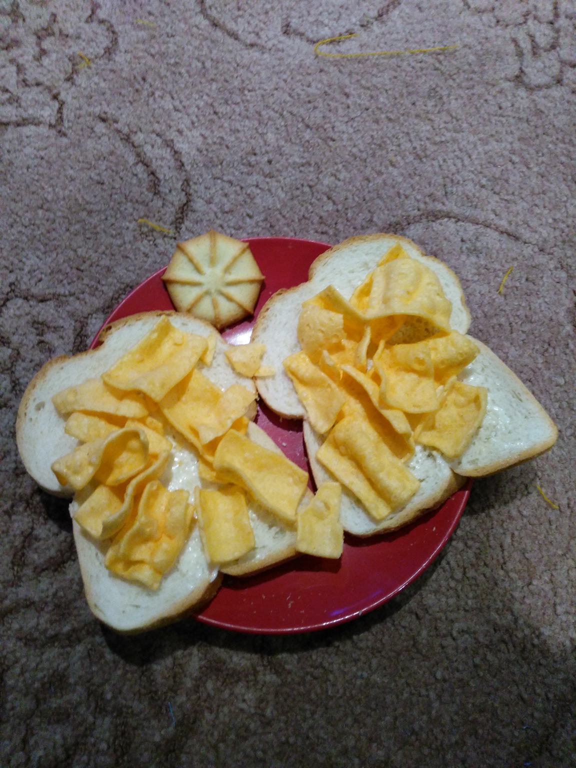 Corn snacks on buttered white bread with biscuit