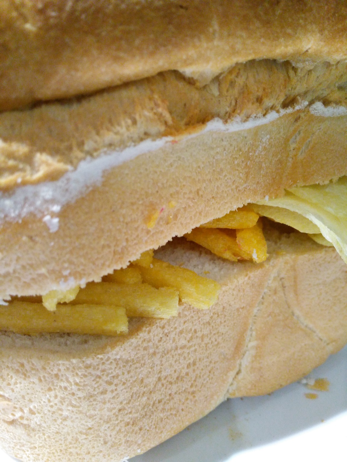 Close-up of Chipsticks and crisps in a loaf