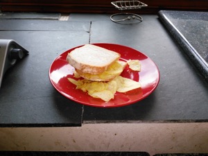 Potato crisps in and around sliced white bread