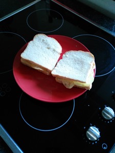 Two sandwiches containing potato crisps