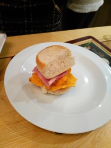 Dainty white roll containing ham and Doritos