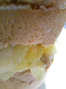 Close-up of potato crisps in sliced white bread