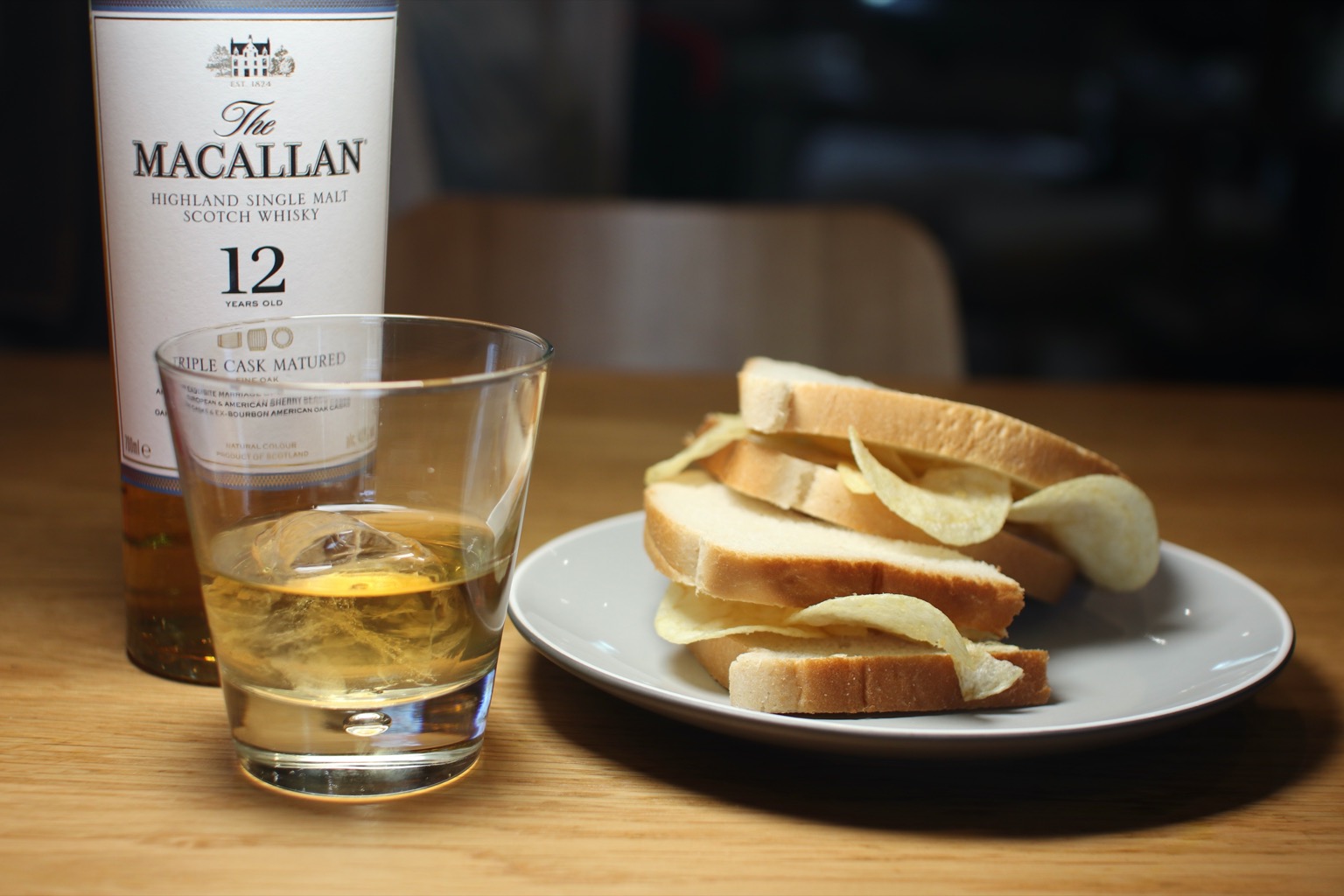 Halved white crisp sandwich alongside whisky