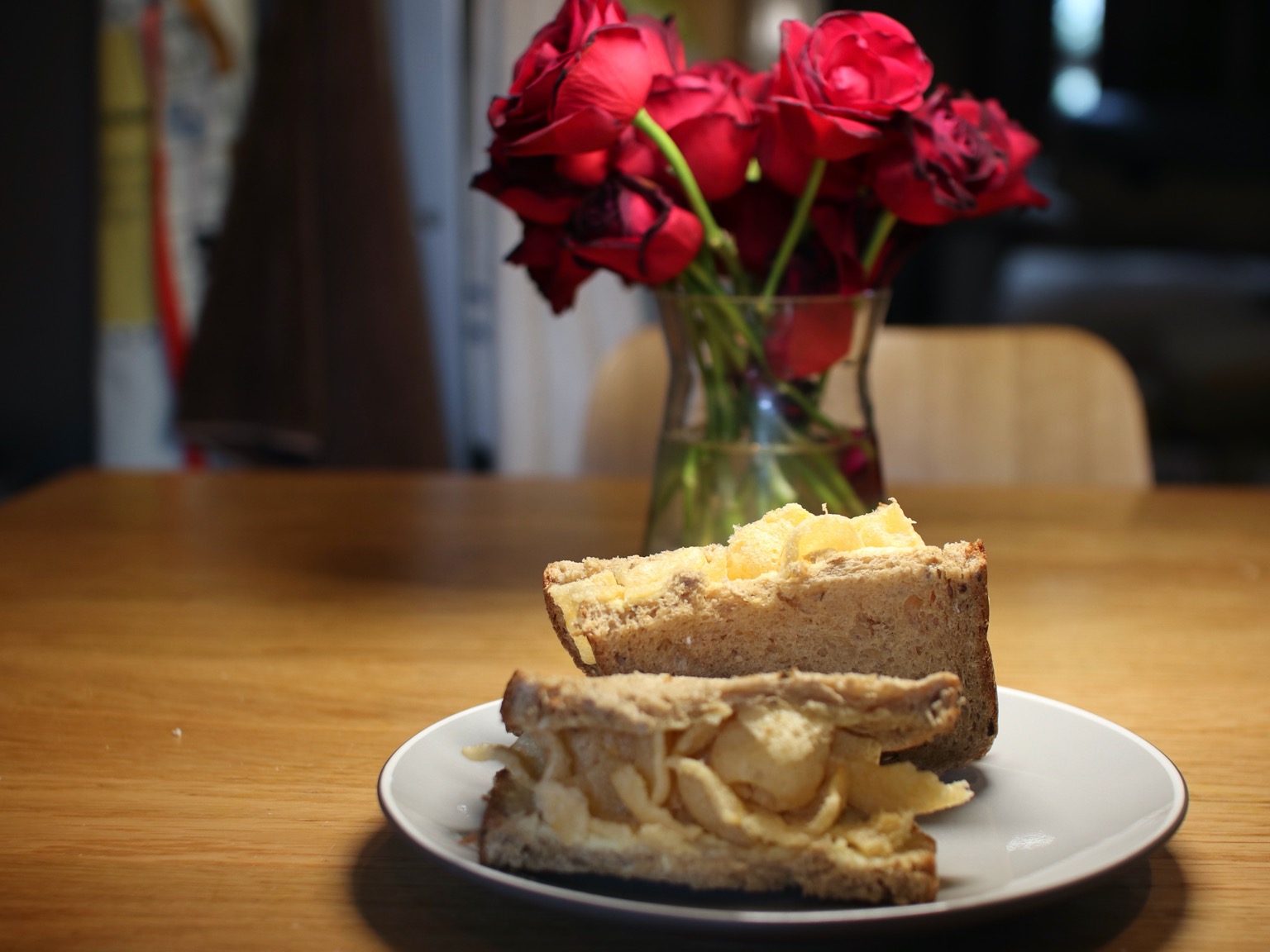 Halved brown Quavers sandwich in front of roses