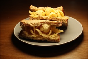 Brown Quavers sandwich cut in half under spotlight