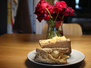 Halved brown Quavers sandwich in front of roses