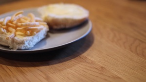 Turning to reveal French Fries on an open white roll