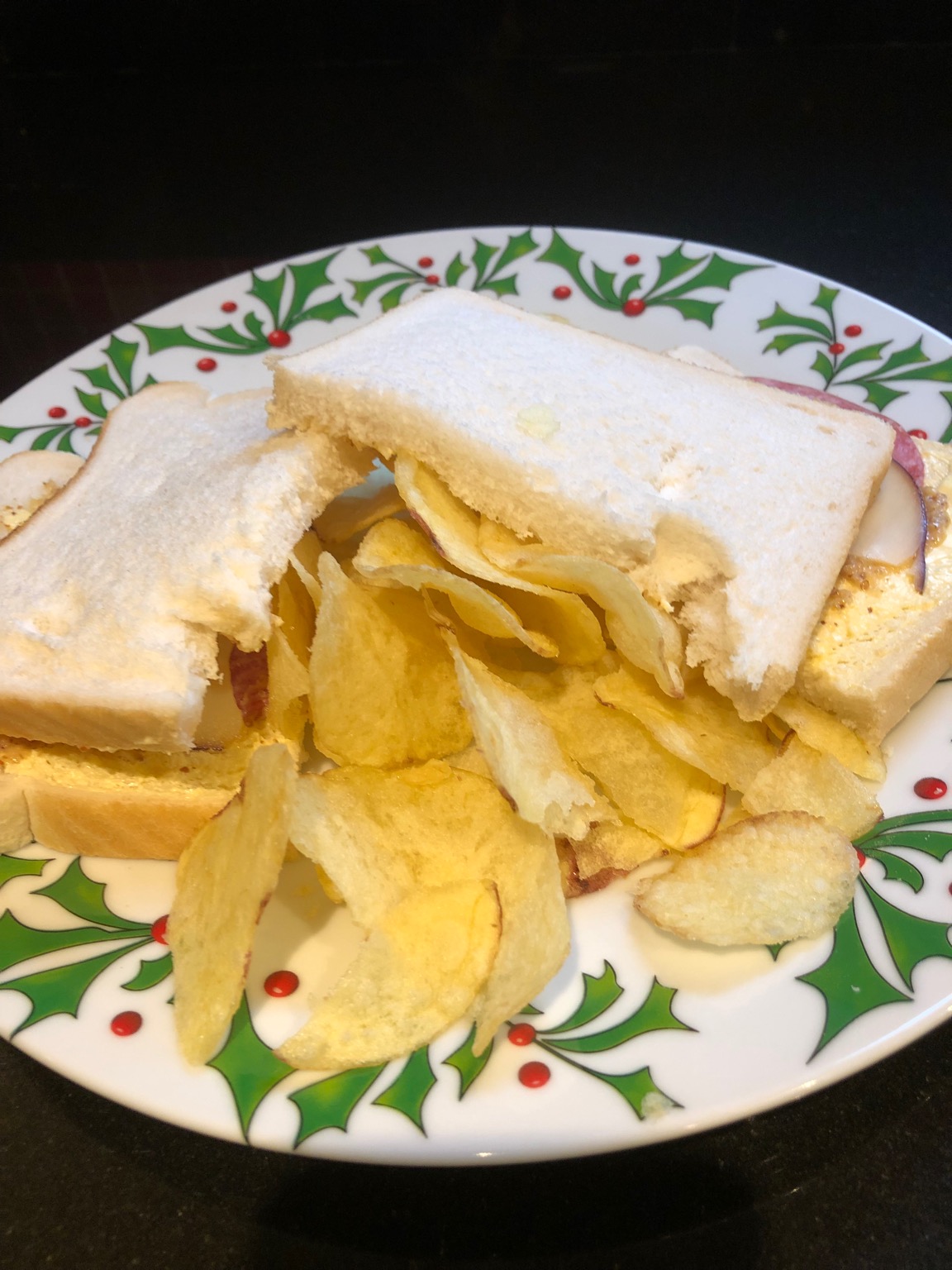 Crisps within and around white sliced bread