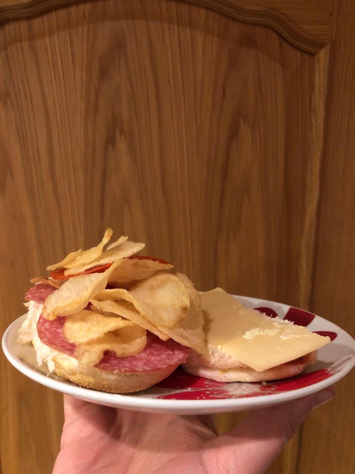 Crisps, cheese and salami on an open roll