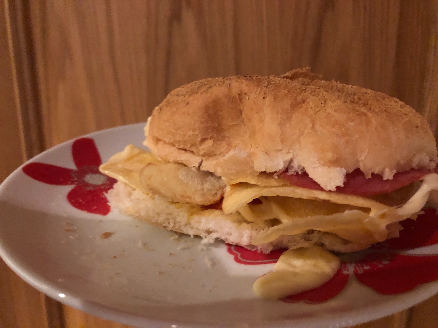 Crisps, cheese and salami in a white roll