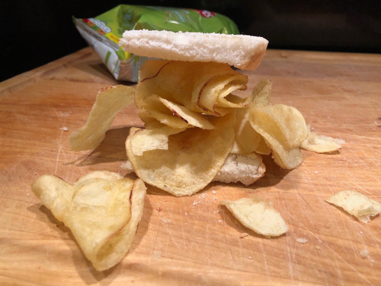 White sliced bread overflowing with potato crisps