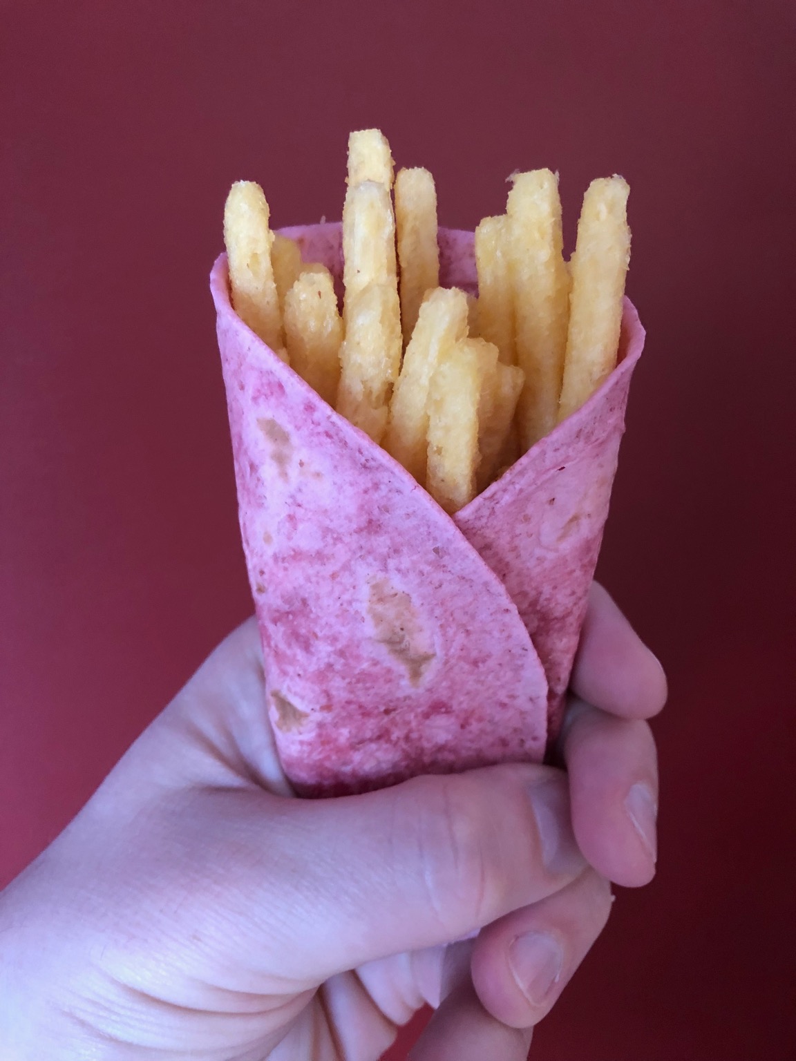 Chipsticks held in a pink tortilla wrap