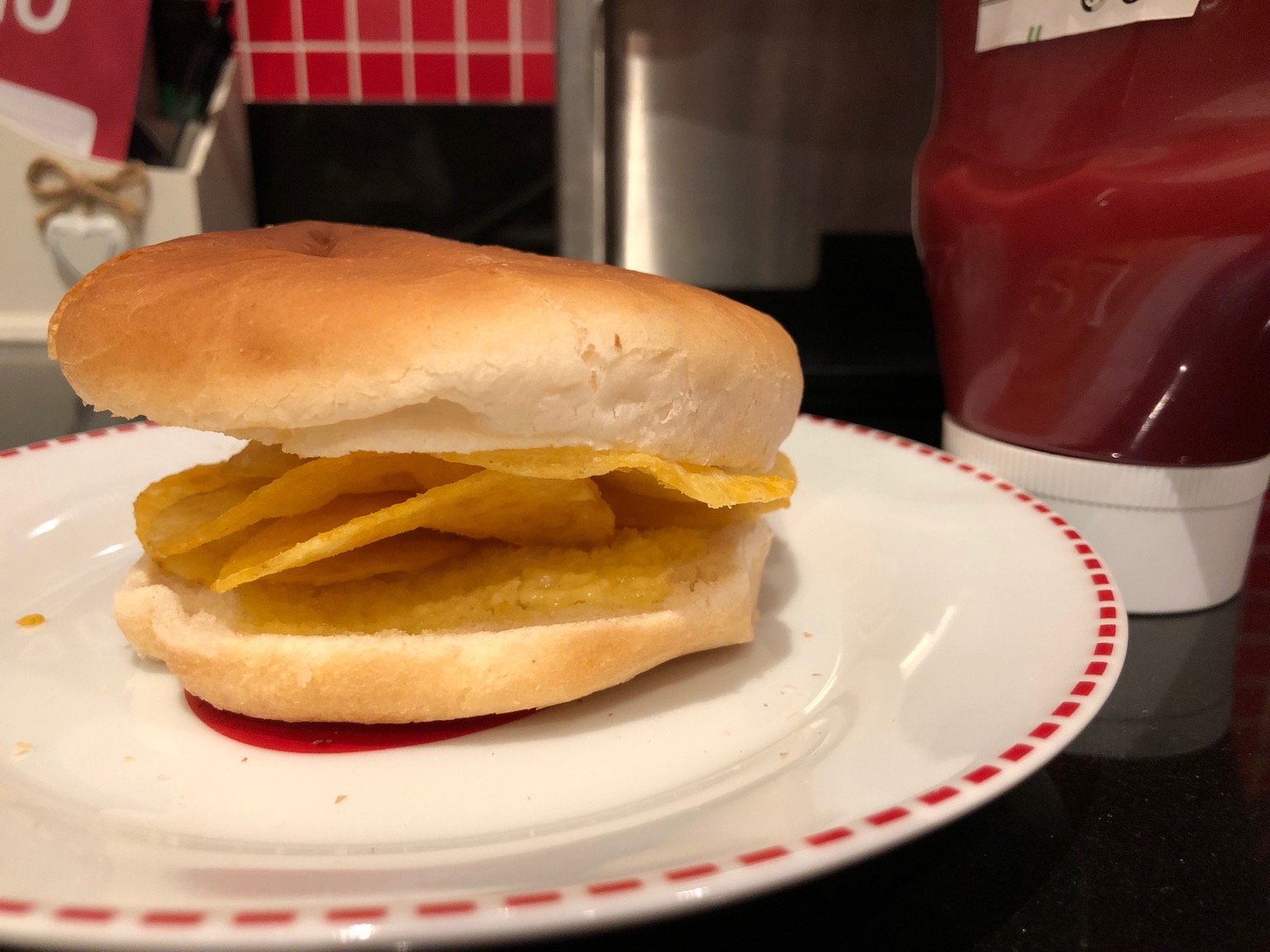 Buttered white roll containing potato crisps