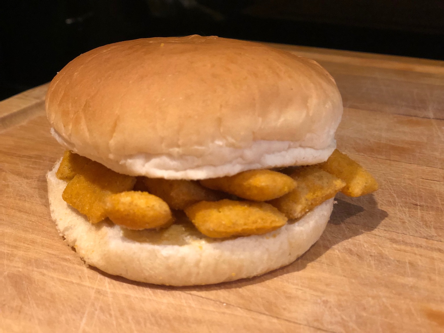 Buttered white roll containing Scampi Fries