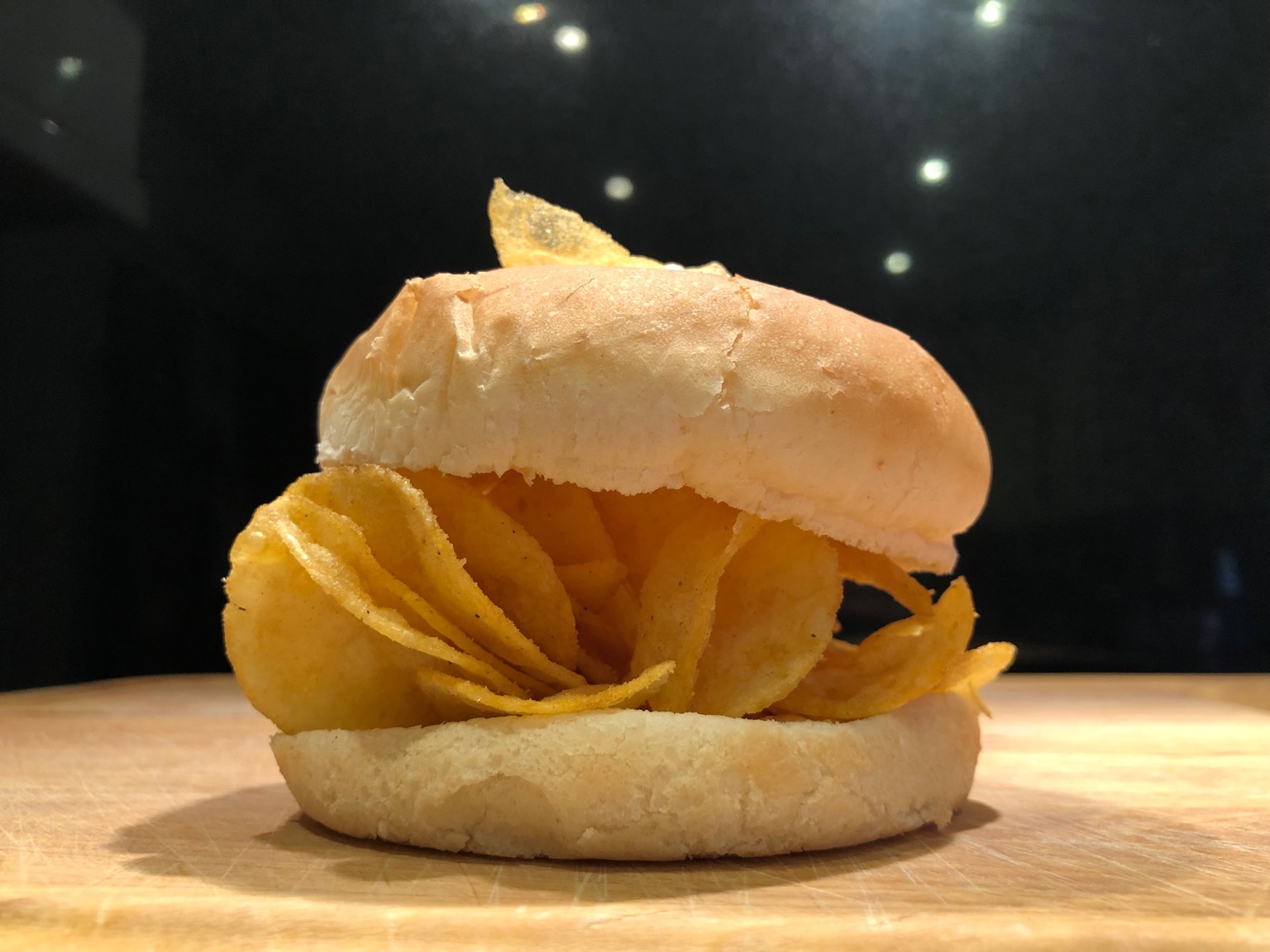 Close-up of crisps within and on a white roll
