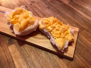 Corn snacks on an open white roll