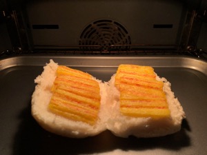 Frazzles on an open white roll in an oven