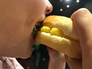 Close-up of eating white roll containing Chipsticks