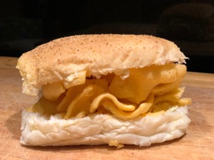 Close-up of a white roll containing corn snacks