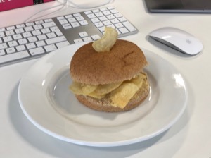 Potato crisps in and on a brown roll