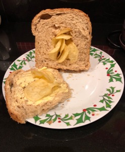 Crisps on and bursting through brown bread