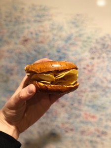 Bagel containing potato crisps held up