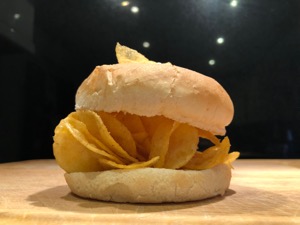 Close-up of crisps within and on a white roll