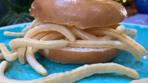 Rotating bagel overflowing with French Fries snacks