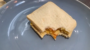 Bitten Quavers and sauce sandwich rotating in slow motion