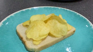 Potato crisps on white bread rotating in slow motion