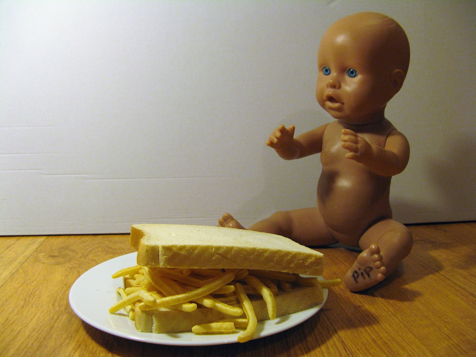 French Fries sandwich alongside a doll