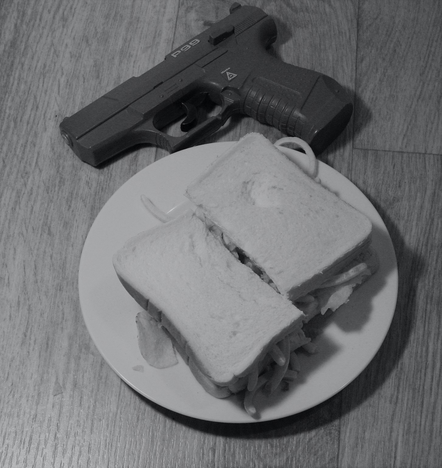 Halved crisps/French Fries sandwich with a toy gun