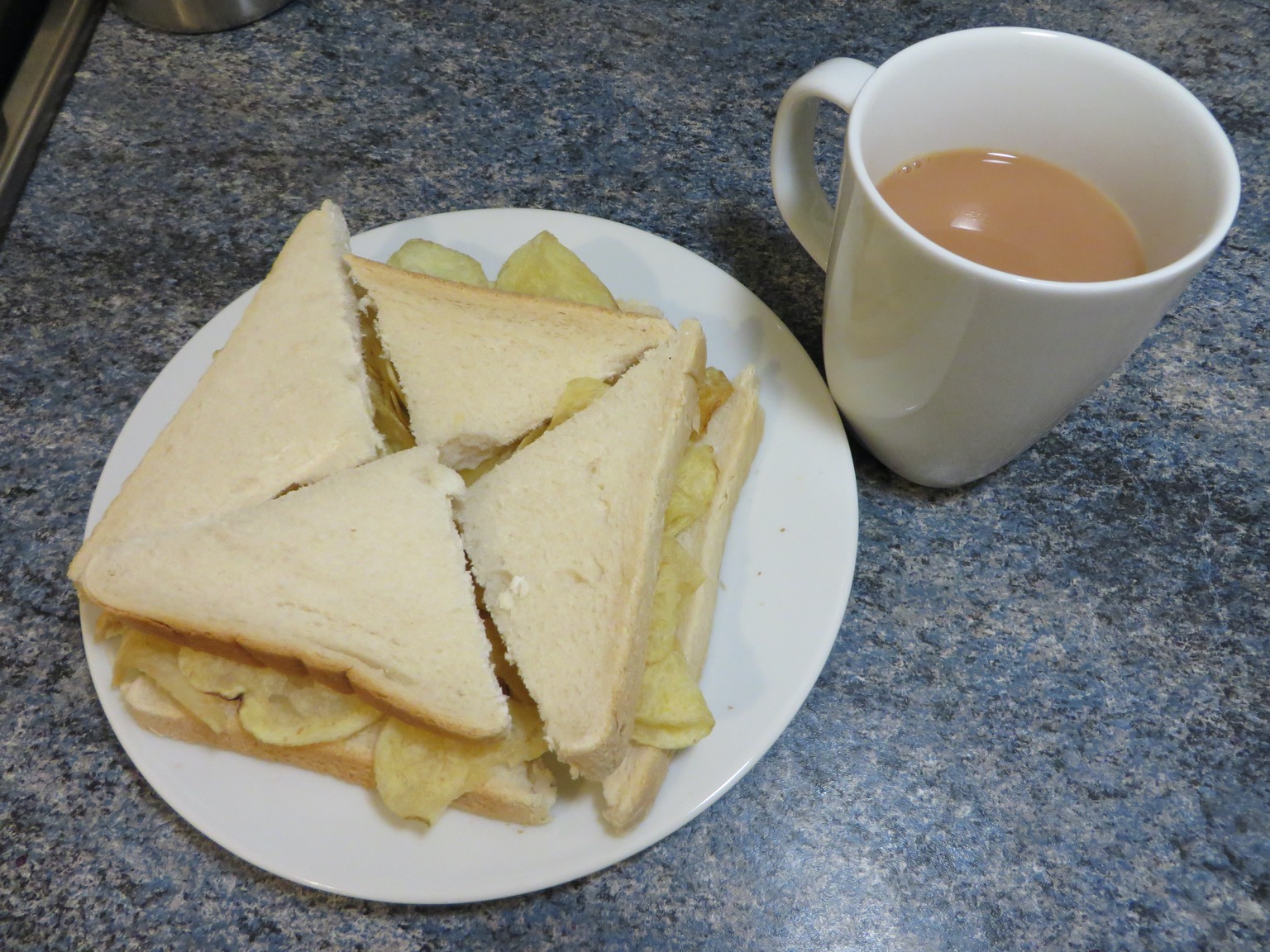 White crisp sandwich alongside a mug of tea