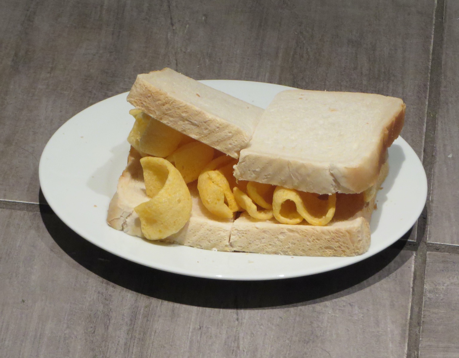 White bread filled with Quavers and cut in half