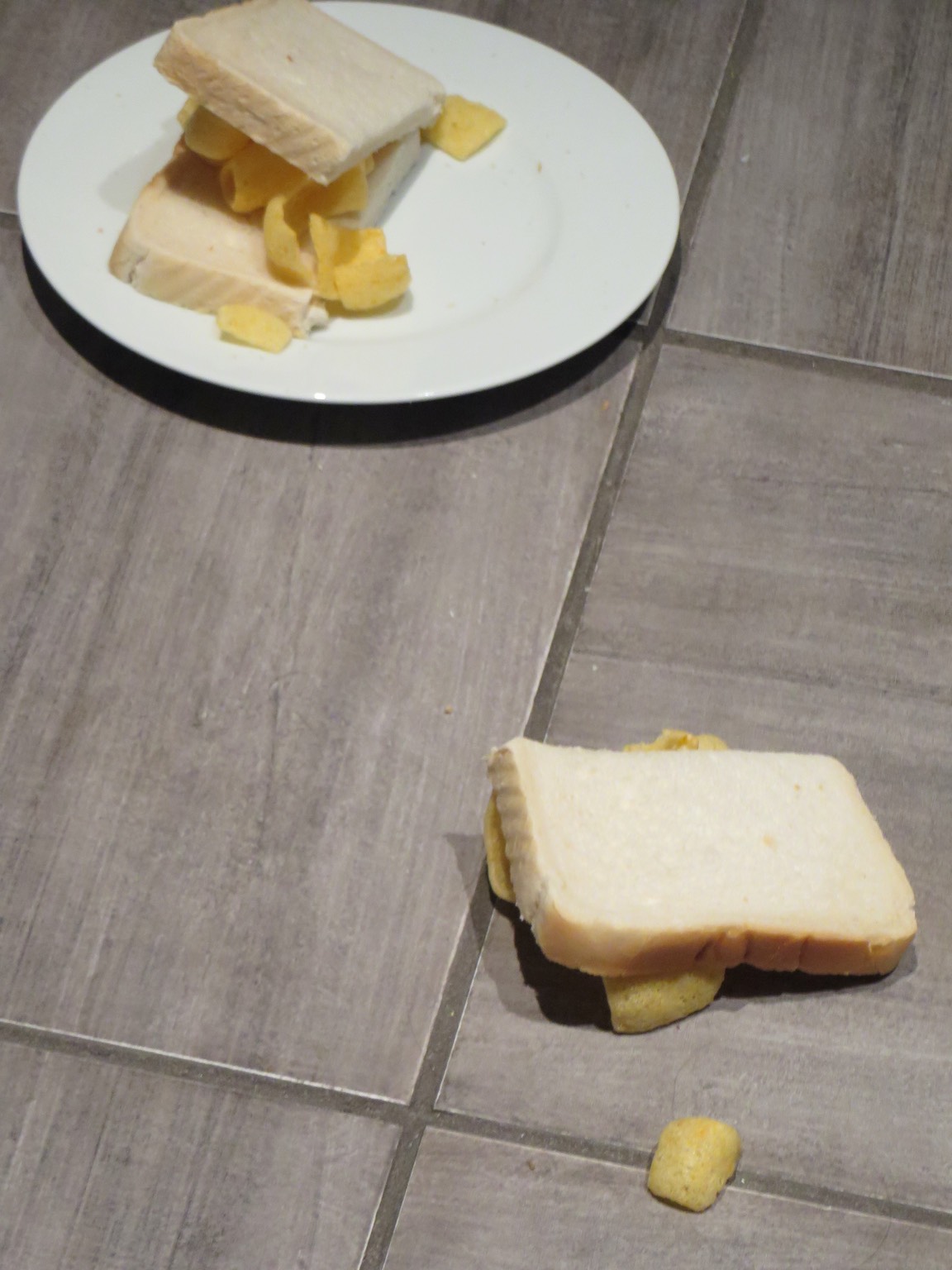 Halved and dismantled white Quavers sandwich