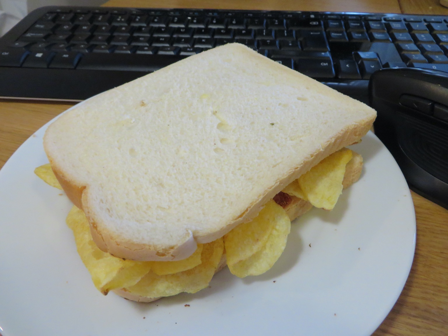 Crisp-filled white sandwich in front of a keyboard