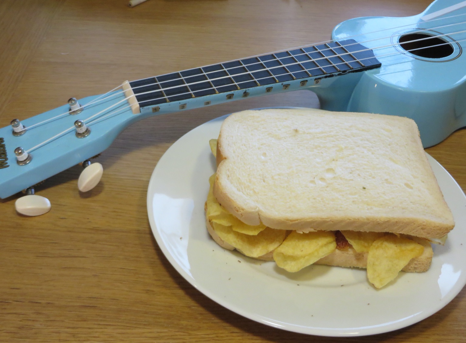 Crisp-filled white sandwich alongside a blue ukulele
