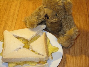 Quartered crisp sandwich with a teddy bear