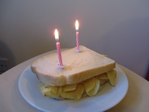 Two birthday candles on a white crisp sandwich