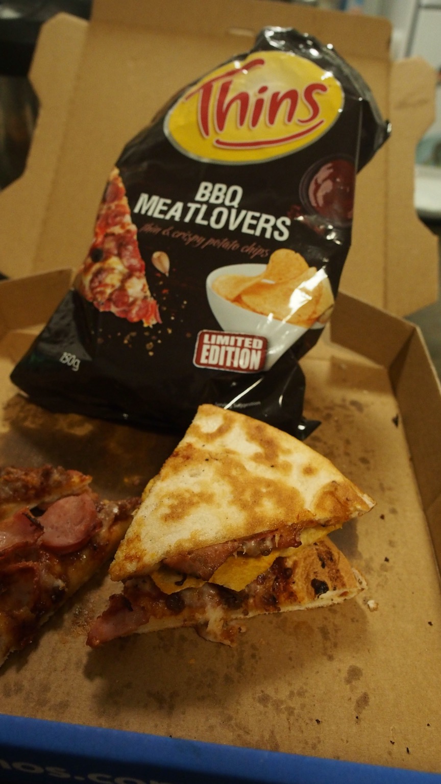Pizza crisp sandwich alongside bag and more pizza